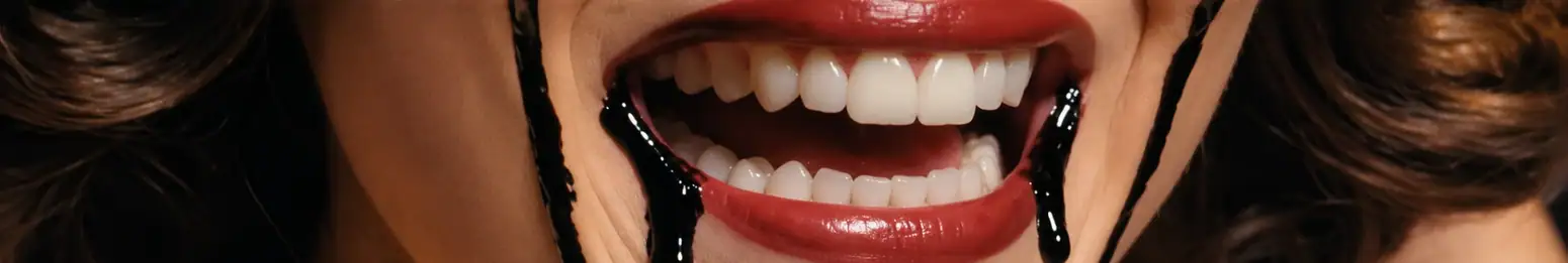 A wide smile beneath black tears